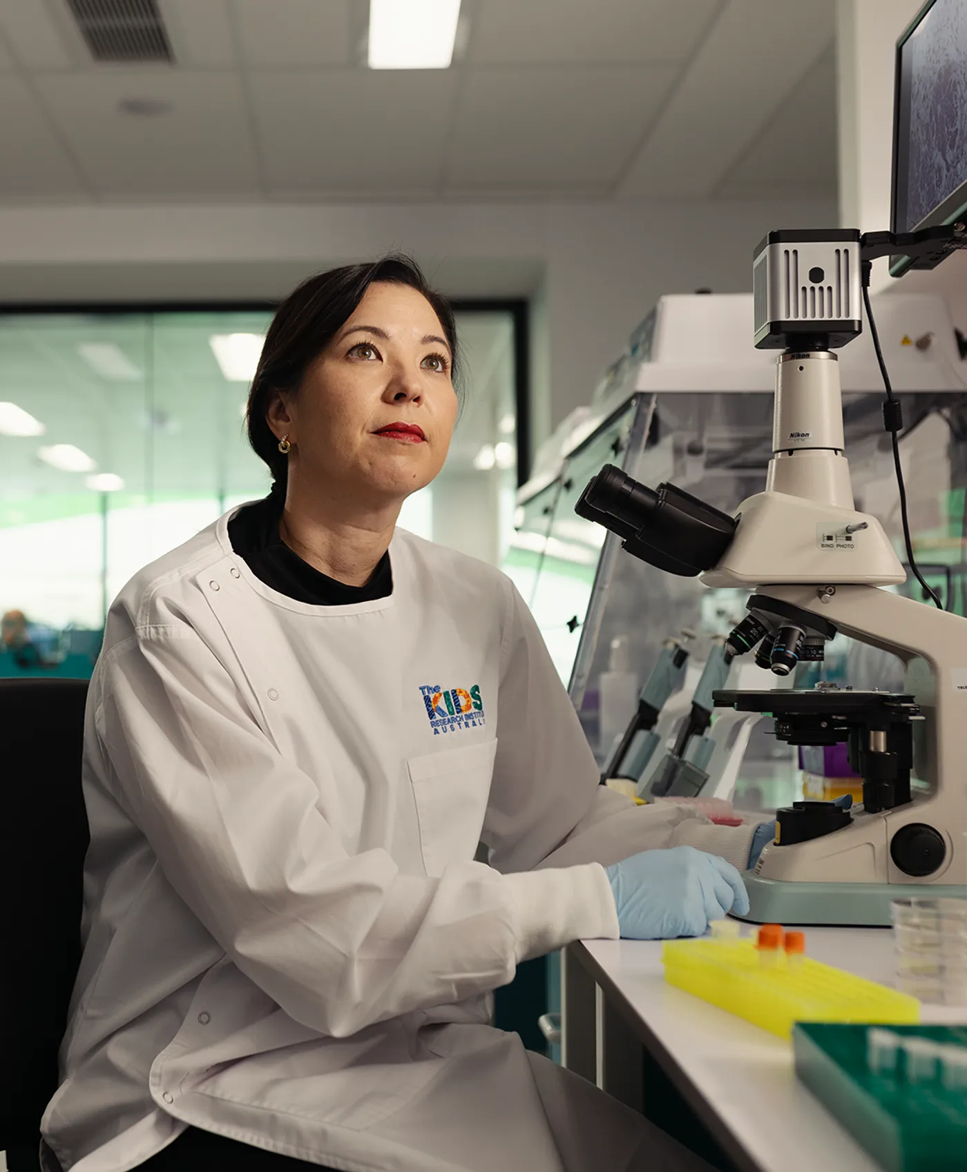 Raelene Endersby at microscope in lab