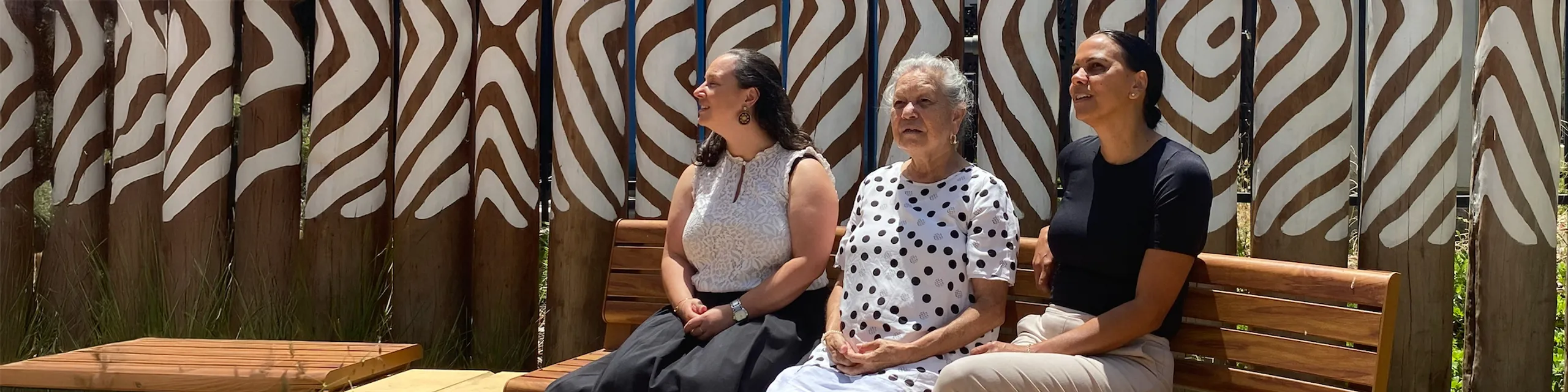 three women looking at the sky.