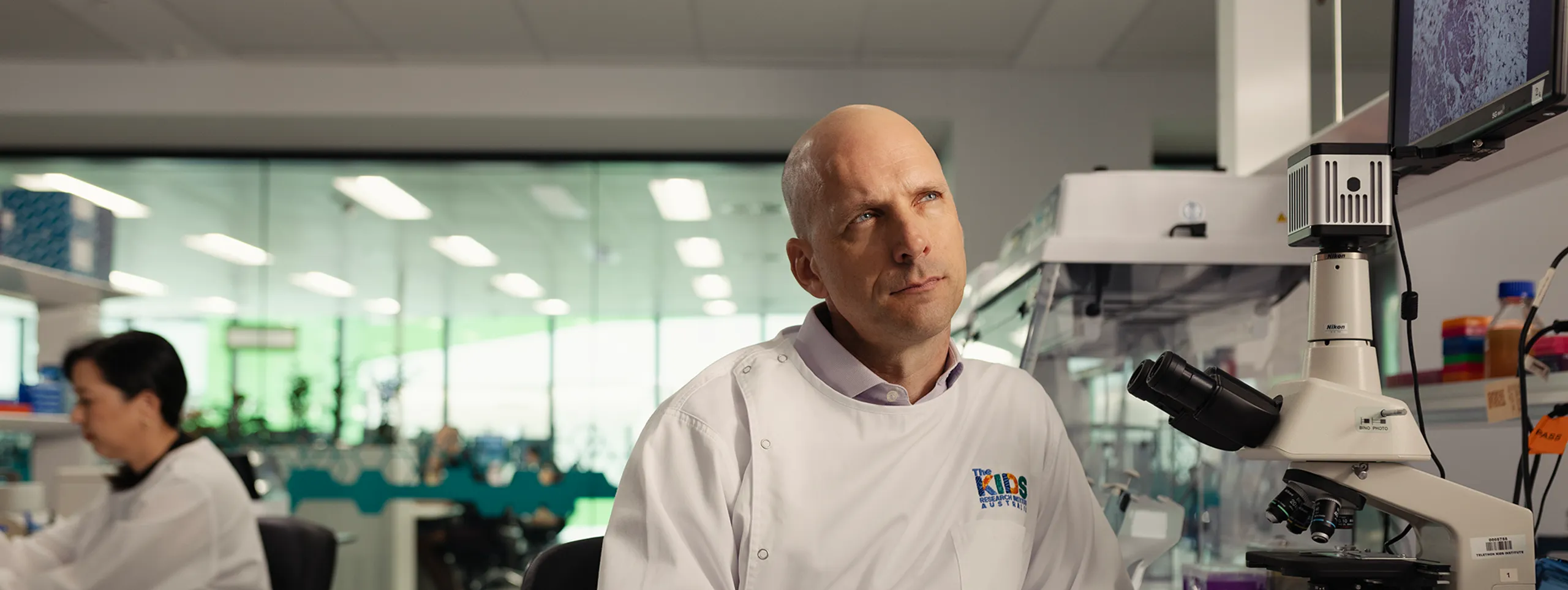 A man in a lab looking with a thinking face.
