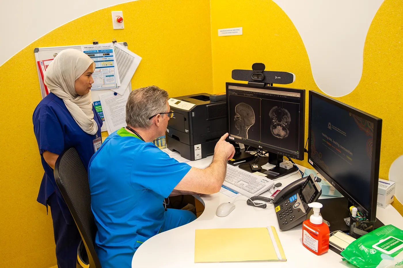 Two clinicians at computer screens.
