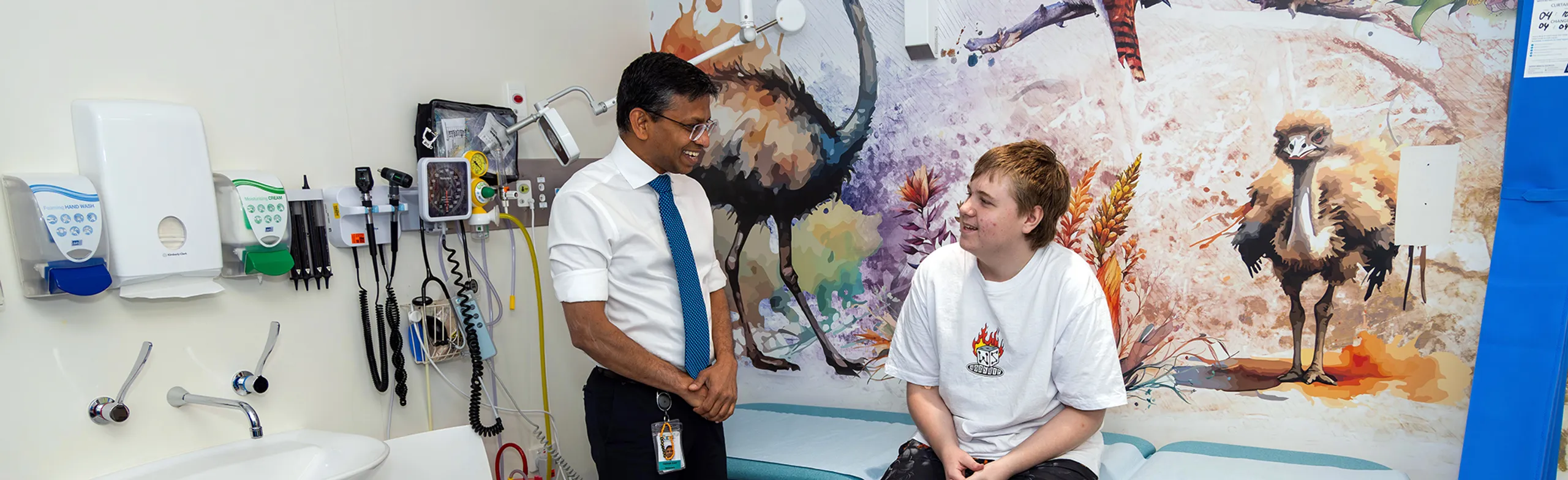 Clinician speaking to adolescent cancer patient