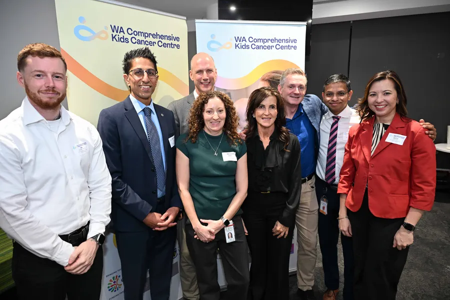 Many people standing in front of the WA Comprehensive Kids Cancer Centre banners.