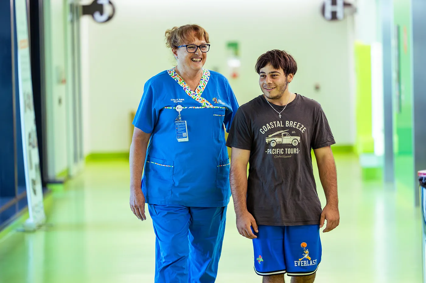 nurse walking adolescent patient