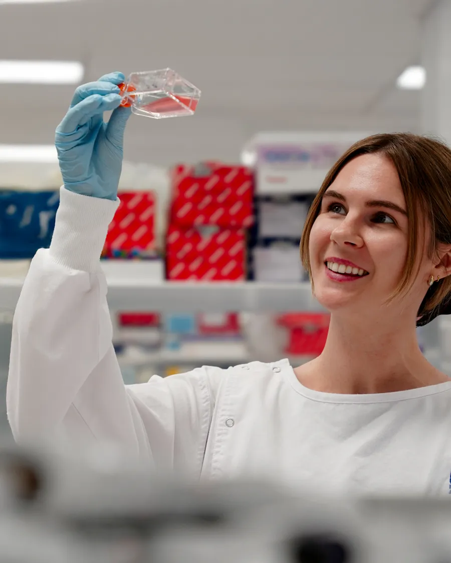 A scientist holding up a sample