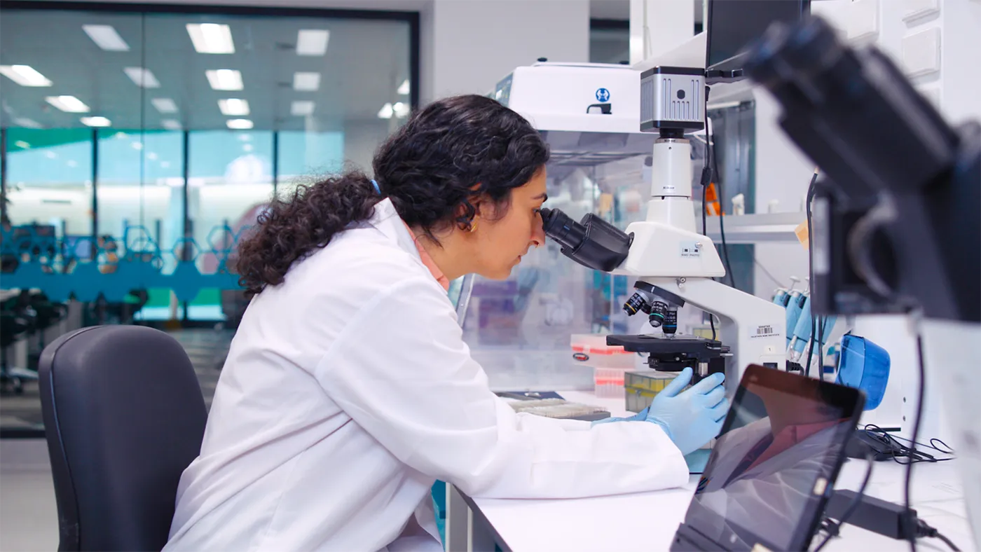 scientist at microscope