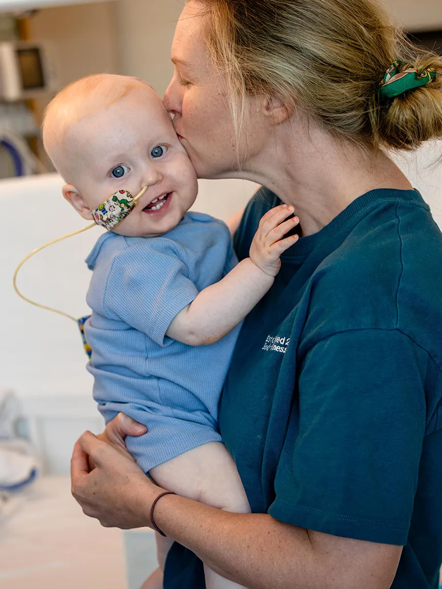 baby kissed on the head by mum