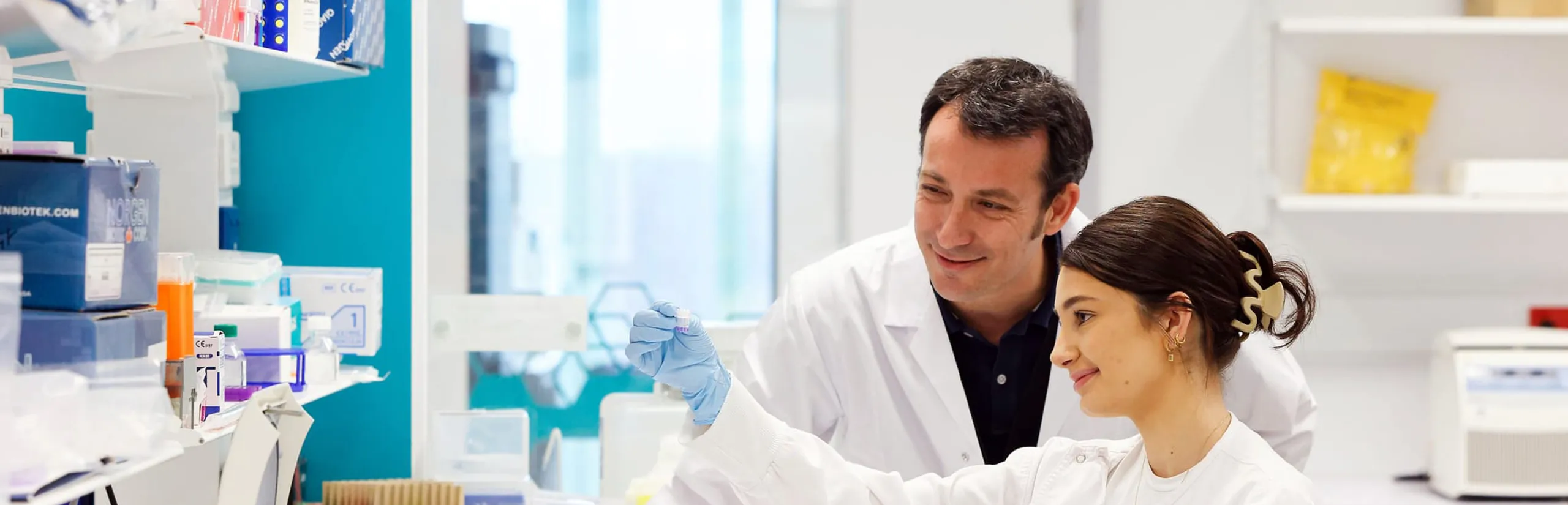 Two people working in a lab looking at a sample