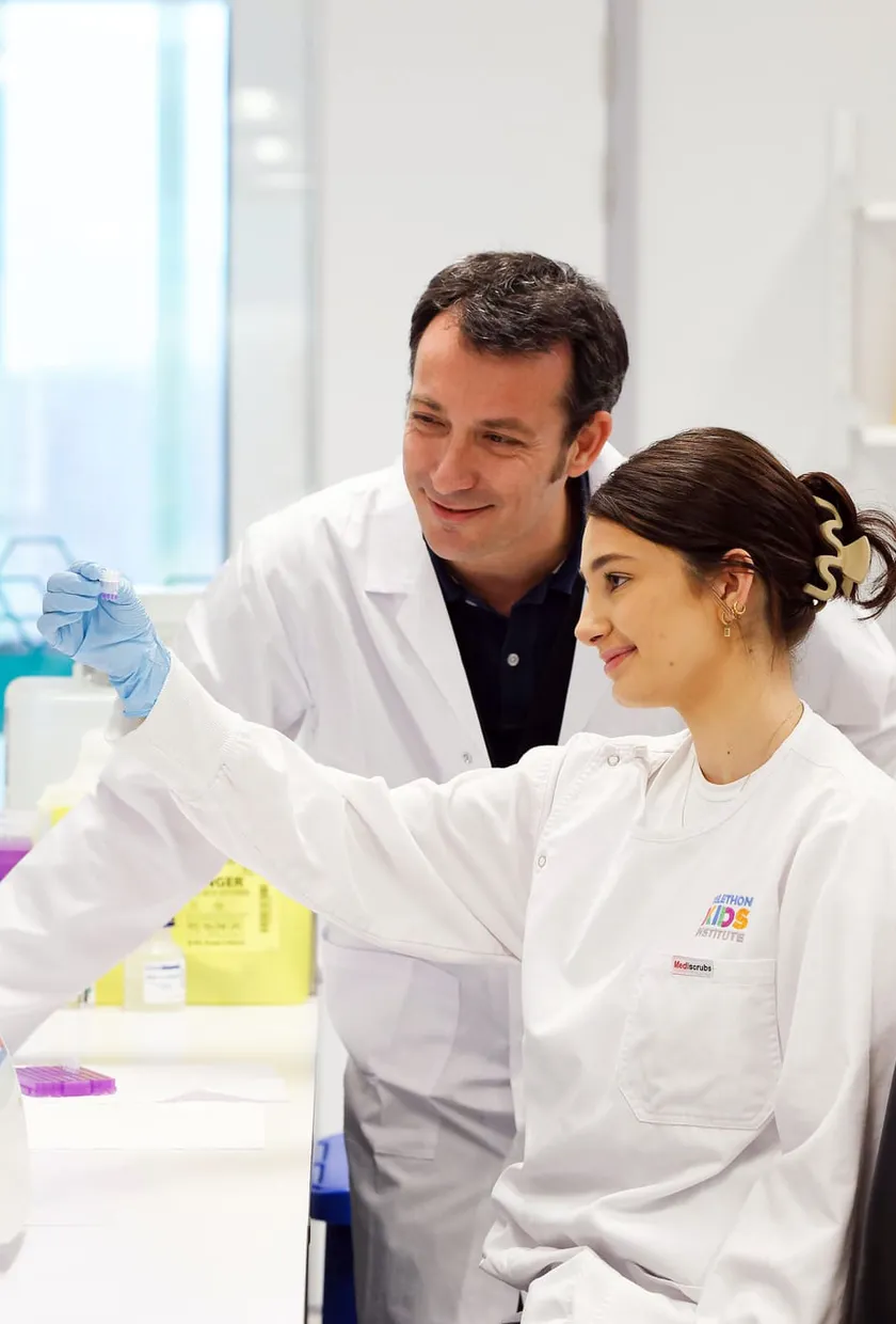 Two people working in a lab looking at a sample